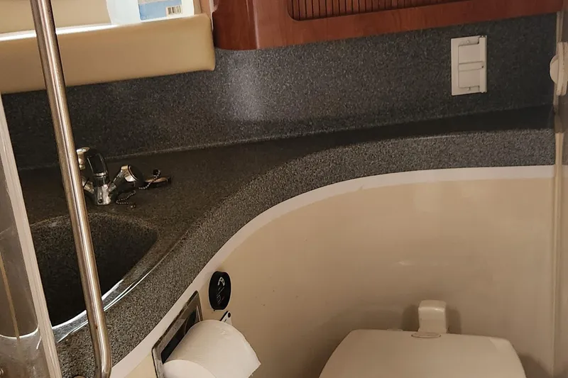 Slide: The Image of Bathroom interior of 2006 Larson 3700 Cabrio boat with sink and toilet. - 16