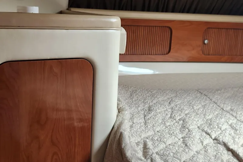 Slide: The Image of Interior cabin of a 2006 Larson 3700 Cabrio boat with wood paneling and bed. - 17