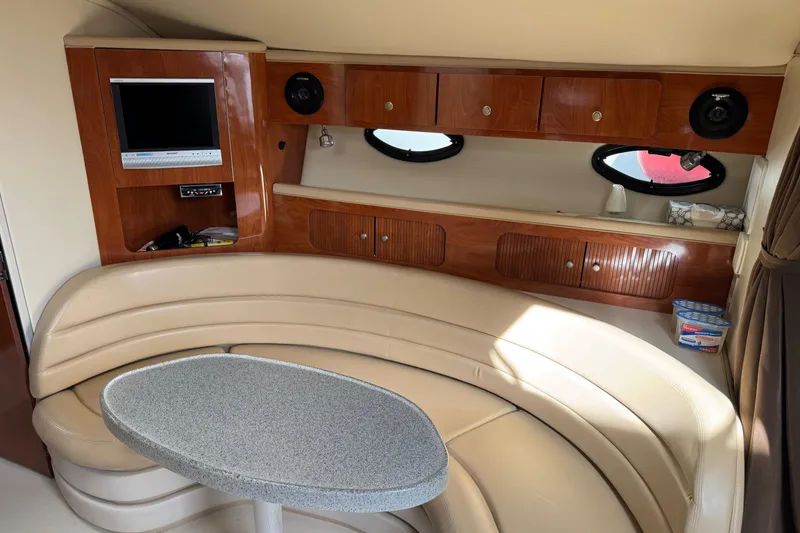 Slide: The Image of Interior of 2006 Larson 3700 Cabrio yacht with leather seating and wood cabinetry. - 18