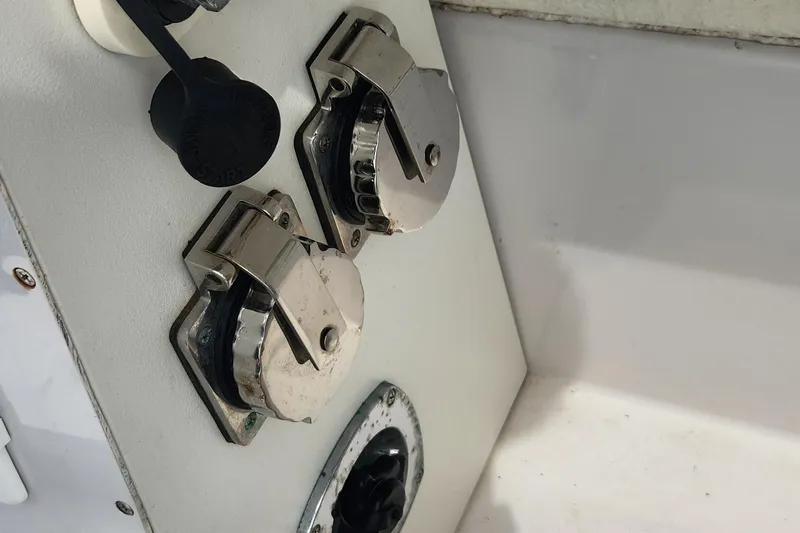 Slide: The Image of Boat electrical outlets on a 2006 Larson 3700 Cabrio, featuring metal covers. - 19
