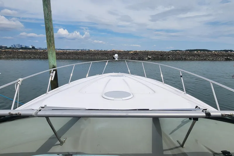 Slide: The Image of 2006 Larson 3700 Cabrio boat on calm water, clear sky in background. - 6
