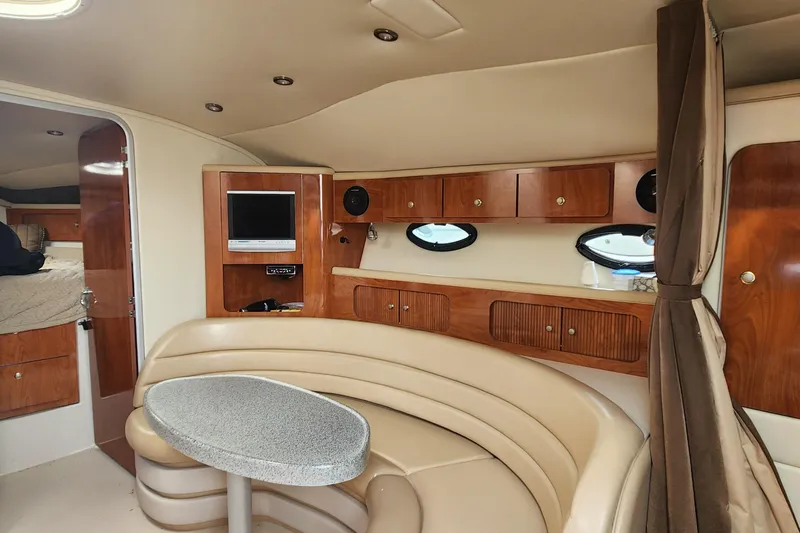 Slide: The Image of Interior of 2006 Larson 3700 Cabrio yacht with cozy seating and wooden cabinetry. - 8