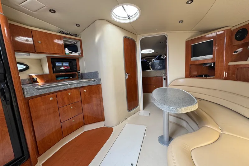 Slide: The Image of Interior of 2006 Larson 3700 Cabrio yacht with kitchenette and seating area. - 9