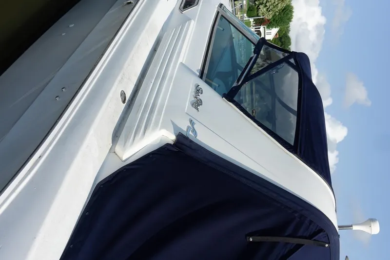 Slide: The Image of 1993 Sea Ray 400 Express Cruiser with blue canopy, docked under clear skies. - 10