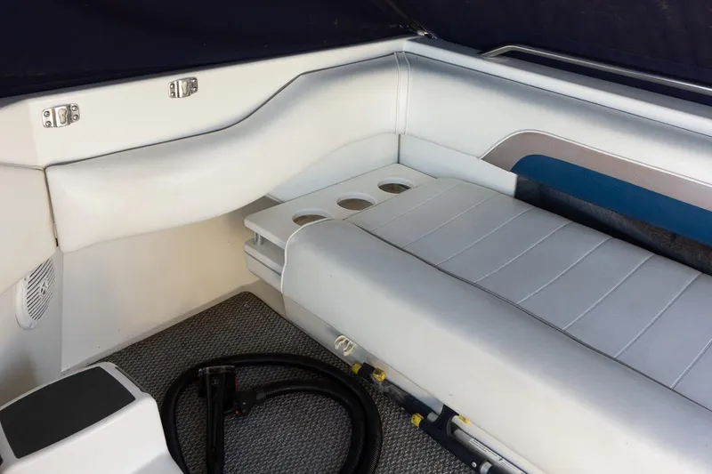 Slide: The Image of Interior seating of 1993 Sea Ray 400 Express Cruiser with cup holders and carpeted floor. - 18