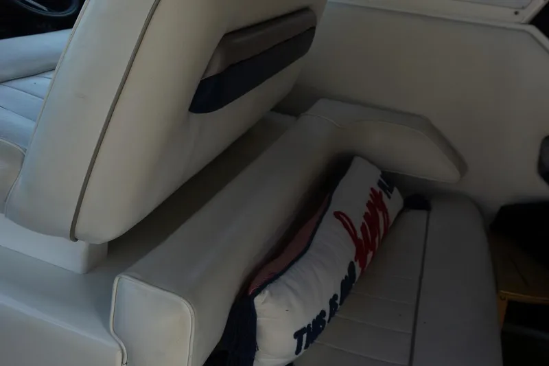 Slide: The Image of 1993 Sea Ray 400 Express Cruiser interior seating with decorative pillow. - 19