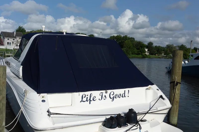 Slide: The Image of 1993 Sea Ray 400 Express Cruiser docked, featuring "Life Is Good!" text on the stern. - 2