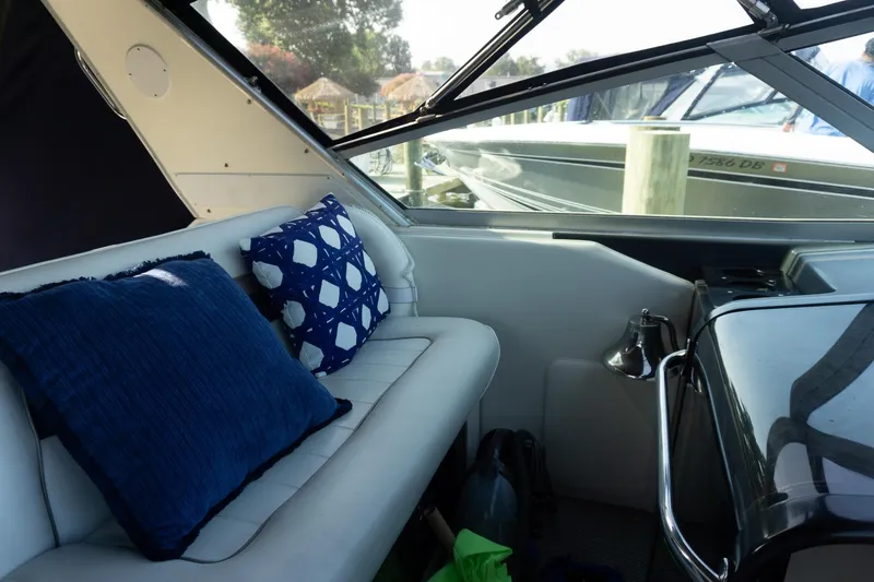 Slide: The Image of Interior of 1993 Sea Ray 400 Express Cruiser with blue cushions and window view. - 20