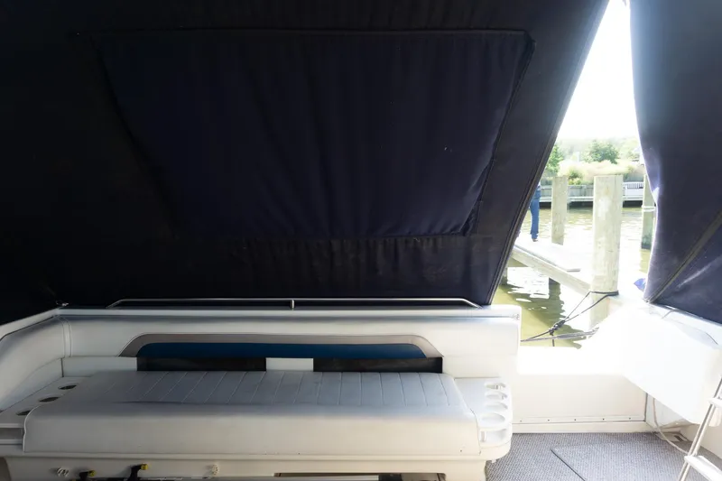 Slide: The Image of 1993 Sea Ray 400 Express Cruiser interior with seating and dock view. - 21
