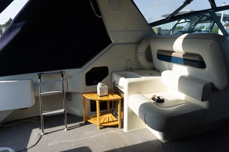 Slide: The Image of Interior of 1993 Sea Ray 400 Express Cruiser with seating, table, and ladder. - 22