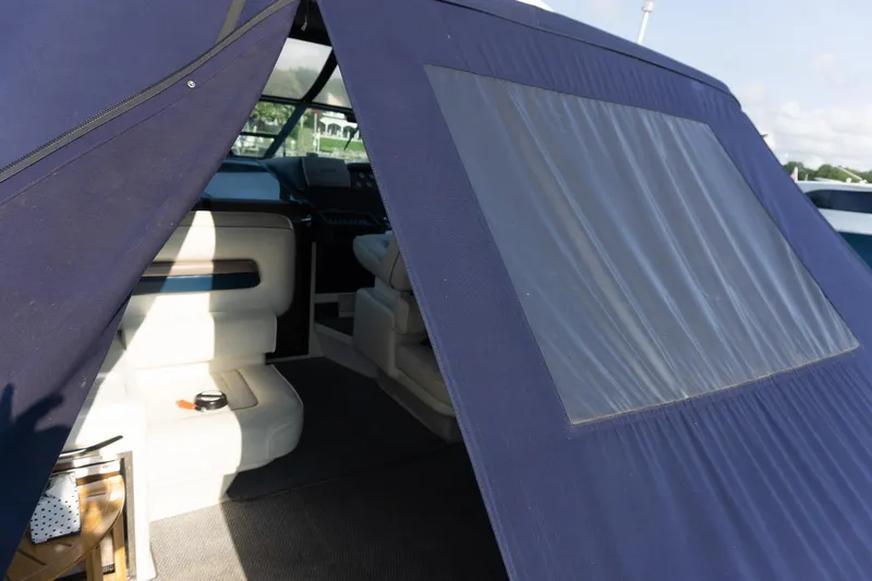 Slide: The Image of 1993 Sea Ray 400 Express Cruiser interior with blue canopy and seating area. - 23