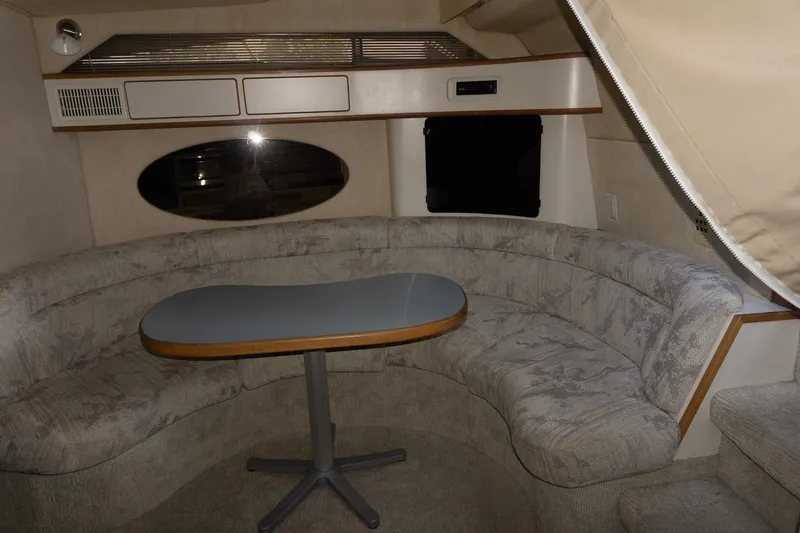 Slide: The Image of Interior of 1993 Sea Ray 400 Express Cruiser with curved seating and table. - 25