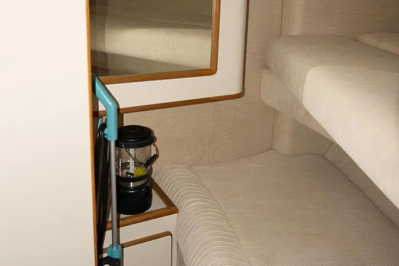 Slide: The Image of Interior of 1993 Sea Ray 400 Express Cruiser with beige upholstery and a lantern. - 29