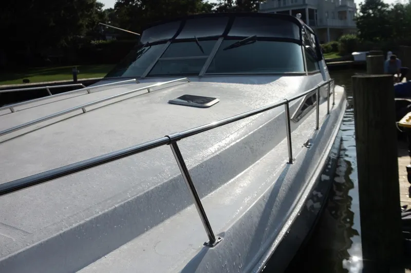 Slide: The Image of 1993 Sea Ray 400 Express Cruiser docked, showcasing sleek design and polished exterior. - 3