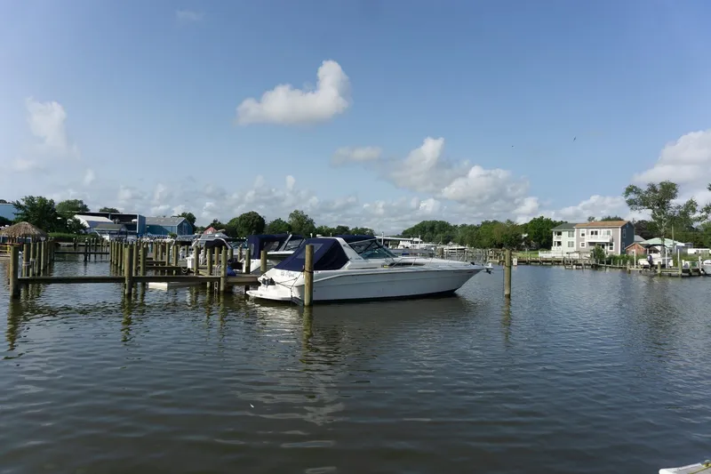 Slide: The Image of 1993 Sea Ray 400 Express Cruiser docked in a serene marina setting. - 5