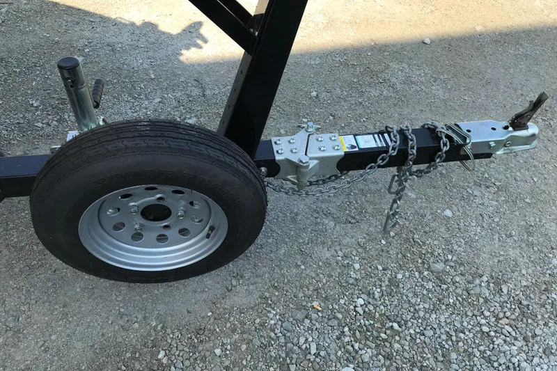 Slide: The Image of Trailer hitch and wheel of a 2013 Lund 1600 Fury Tiller on gravel surface. - 11