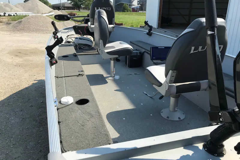 Slide: The Image of 2013 Lund 1600 Fury Tiller boat interior with seats and fishing equipment. - 12