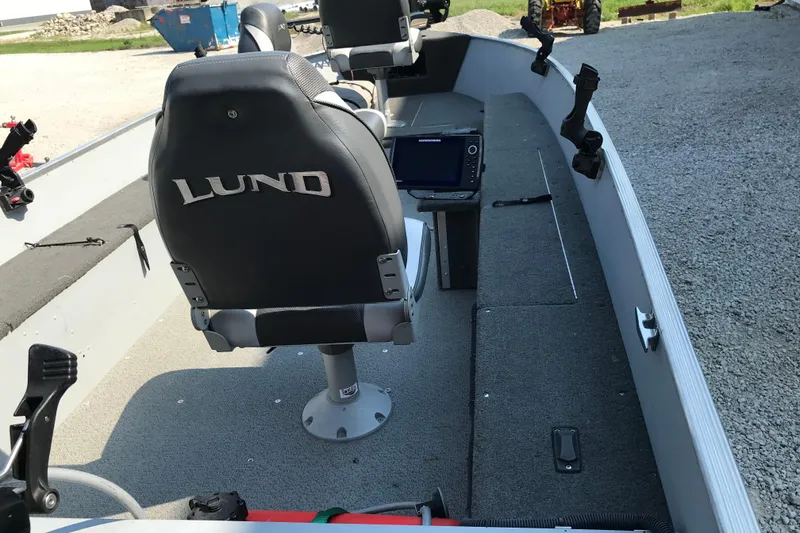 Slide: The Image of 2013 Lund 1600 Fury Tiller boat interior with seating and navigation equipment. - 13