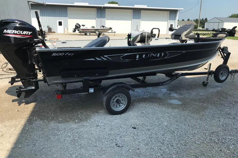 Slide: The Image of 2013 Lund 1600 Fury Tiller boat with Mercury engine on a trailer. - 4