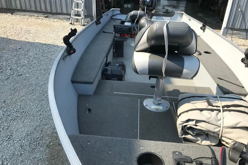 Slide: The Image of 2013 Lund 1600 Fury Tiller boat interior with seating and storage compartments. - 9