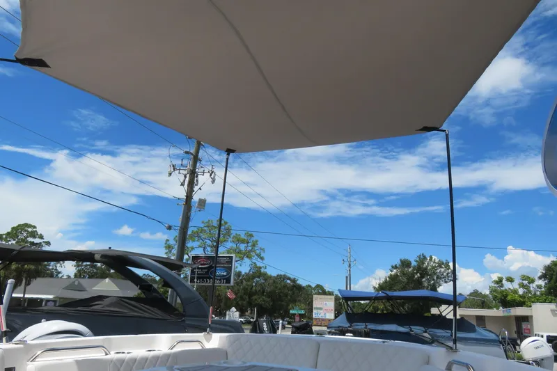 Slide: The Image of 2025 Sea Fox 268 Commander boat with canopy, Sarasota, FL, clear blue sky background. - 18