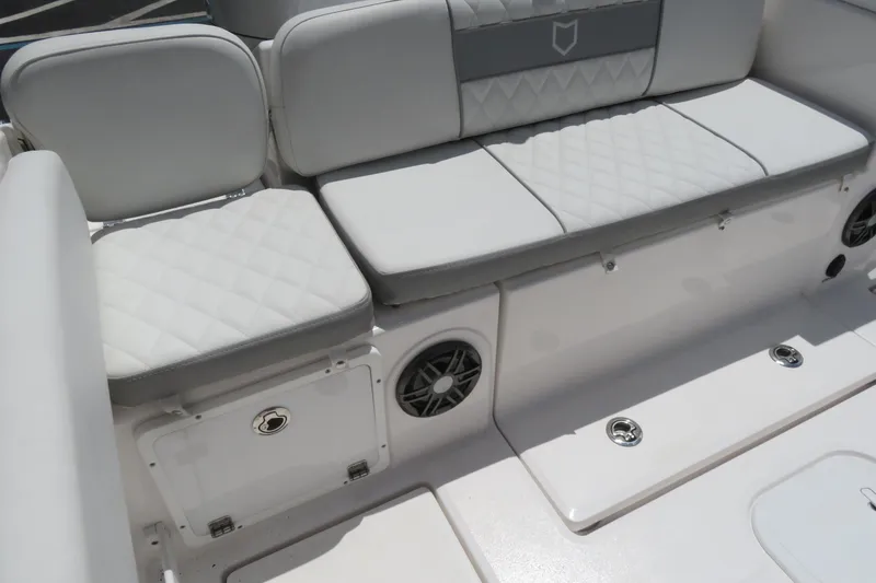 Slide: The Image of Luxurious seating on 2025 Sea Fox 268 Commander boat, featuring quilted upholstery and storage. - 27