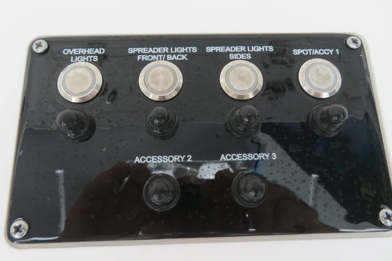 Slide: The Image of Control panel of Sea Fox 268 Commander boat with labeled switches for lights and accessories. - 34