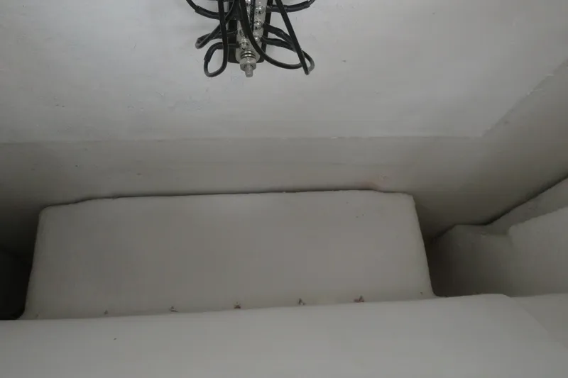 Slide: The Image of Interior view of a 2025 Sea Fox 268 Commander boat, featuring a white cushioned seating area. - 37