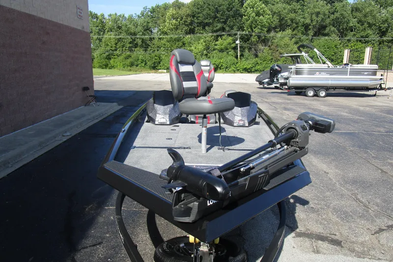 Slide: The Image of 2025 Ranger RT 198 P fishing boat with trolling motor and seating, parked outdoors. - 5