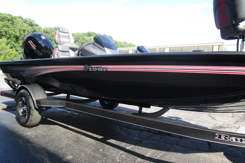 Slide: The Image of 2025 Ranger RT 198 P boat on trailer, black with red accents, parked outdoors. - 6
