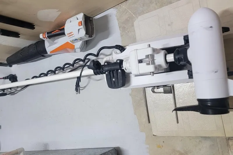 Slide: The Image of 2022 Sundance 20DX electric trolling motor mounted on a boat deck. - 5