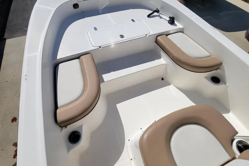 Slide: The Image of 2022 Sundance 20DX boat interior with beige and white cushioned seating. - 6