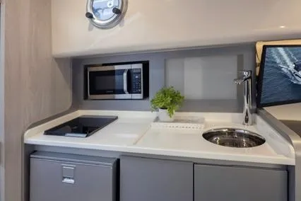 Slide: The Image of 2025 Hanover 387 Classic Luxury Edition yacht kitchenette with modern appliances and sleek design. - 8