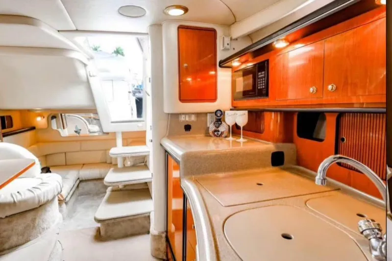 Slide: The Image of Luxurious interior of 2000 Sea Ray 340 Sundancer yacht with modern kitchen amenities. - 4