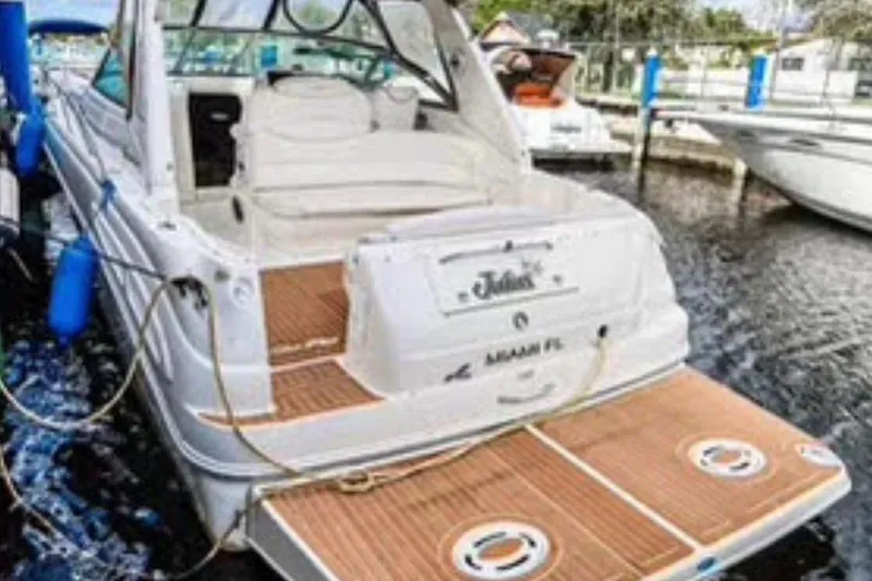 Slide: The Image of 2000 Sea Ray 340 Sundancer docked, featuring spacious deck and elegant design. - 7