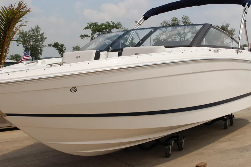The Image of 2025 Cobalt R4 Surf boat on display, sleek white design with black accents. - 1
