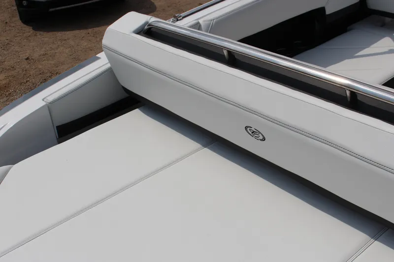 Slide: The Image of 2025 Cobalt R4 Surf boat interior with sleek white seating and stainless steel accents. - 10