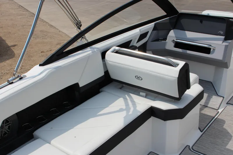 Slide: The Image of 2025 Cobalt R4 Surf boat interior with sleek white seating and modern design. - 12