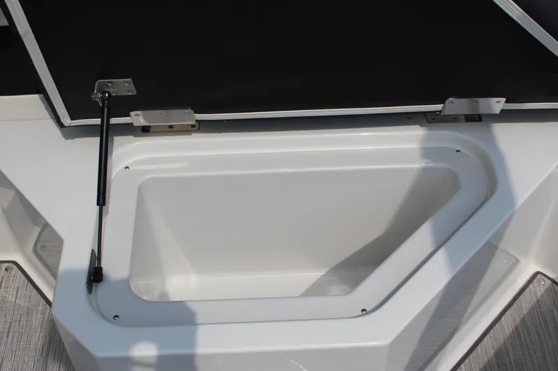 Slide: The Image of 2025 Cobalt R4 Surf boat storage compartment with open lid and hydraulic support. - 13