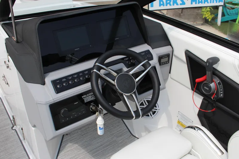 Slide: The Image of 2025 Cobalt R4 Surf boat dashboard with steering wheel and control panel. - 15