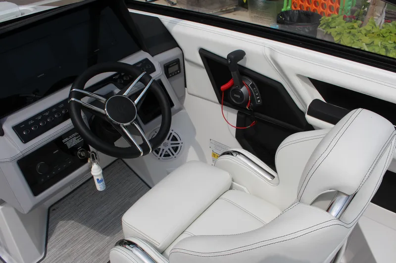 Slide: The Image of Interior of 2025 Cobalt R4 Surf boat with steering wheel and control panel. - 16