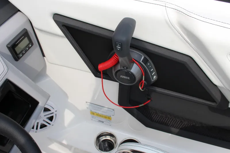 Slide: The Image of Interior of 2025 Cobalt R4 Surf boat with control panel and trim lever. - 17