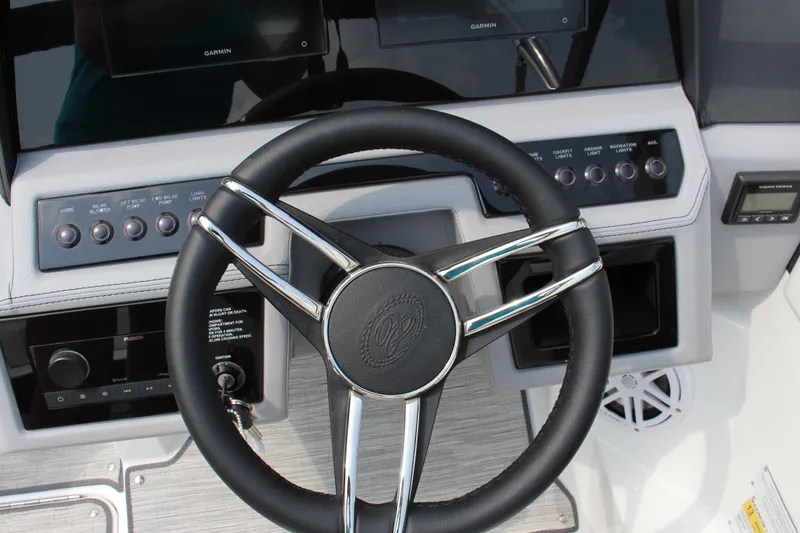 Slide: The Image of Steering wheel and dashboard of 2025 Cobalt R4 Surf boat with control buttons. - 18
