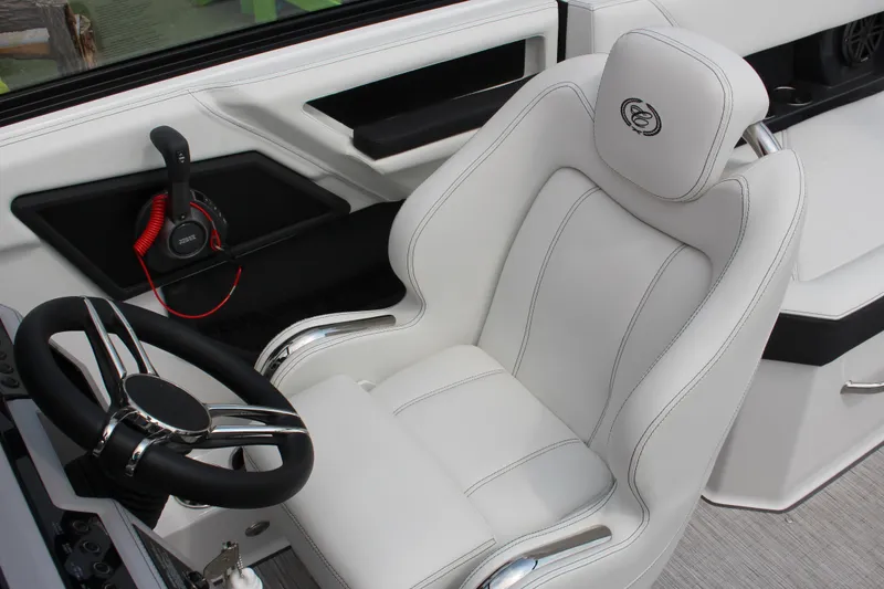 Slide: The Image of Luxury interior of 2025 Cobalt R4 Surf boat with white leather seating and steering wheel. - 21