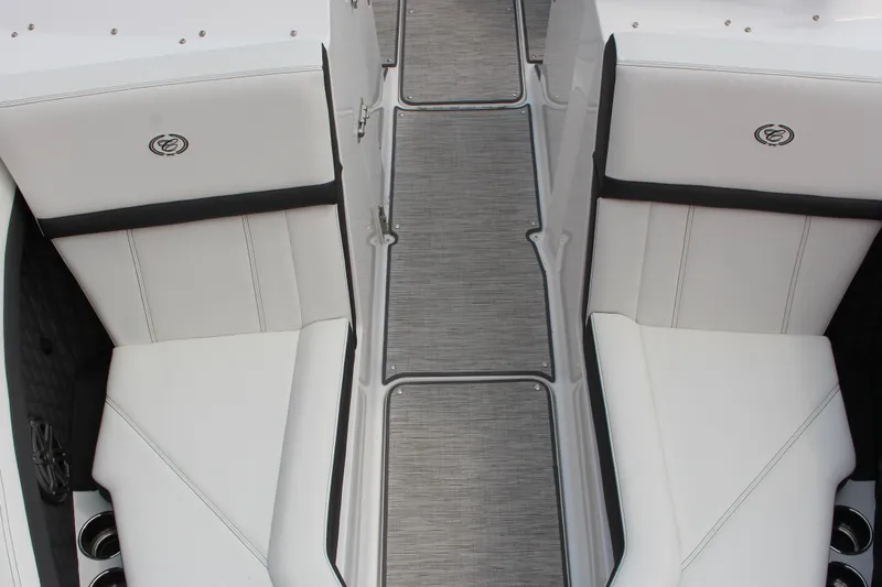 Slide: The Image of 2025 Cobalt R4 Surf boat interior with white seating and sleek design. - 23