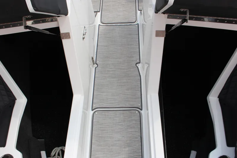 Slide: The Image of 2025 Cobalt R4 Surf boat interior with sleek gray flooring and black seating. - 26