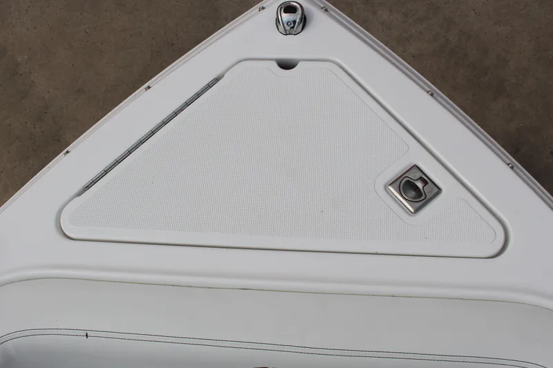 Slide: The Image of Bow storage compartment of 2025 Cobalt R4 Surf boat, featuring sleek design and latch. - 27