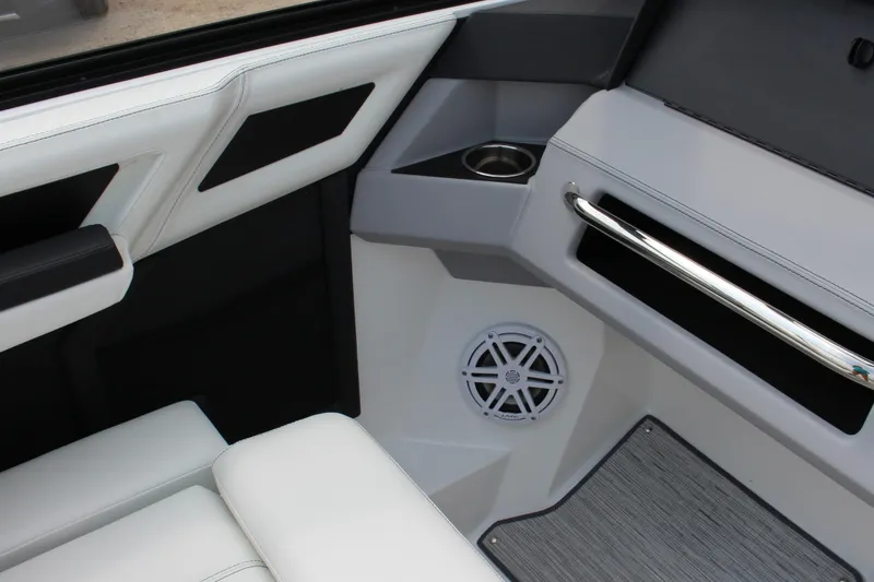 Slide: The Image of 2025 Cobalt R4 Surf interior with white seating, speaker, and cup holder. - 30