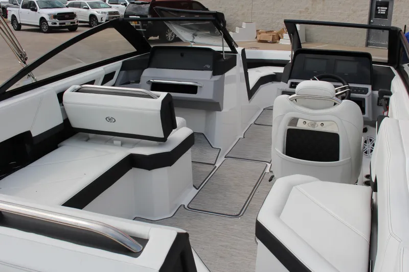 Slide: The Image of 2025 Cobalt R4 Surf boat interior with sleek white seating and modern dashboard design. - 31