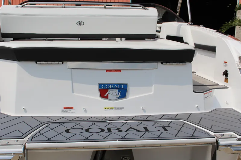 Slide: The Image of 2025 Cobalt R4 Surf boat rear view with logo and seating area. - 6